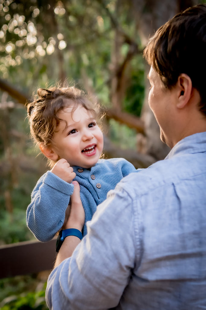 small child looking at father with love and wonder portrait by Shelly Rivoli