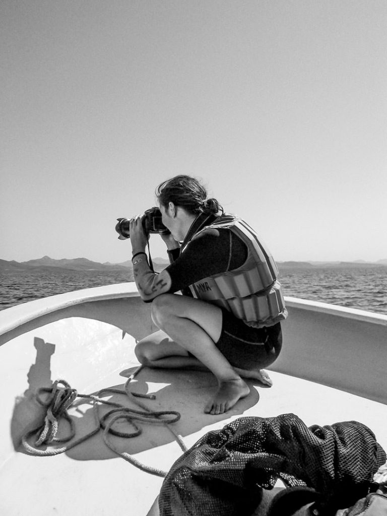 Photographer Shelly Rivoli on the bow of a panga on the Sea of Cortez