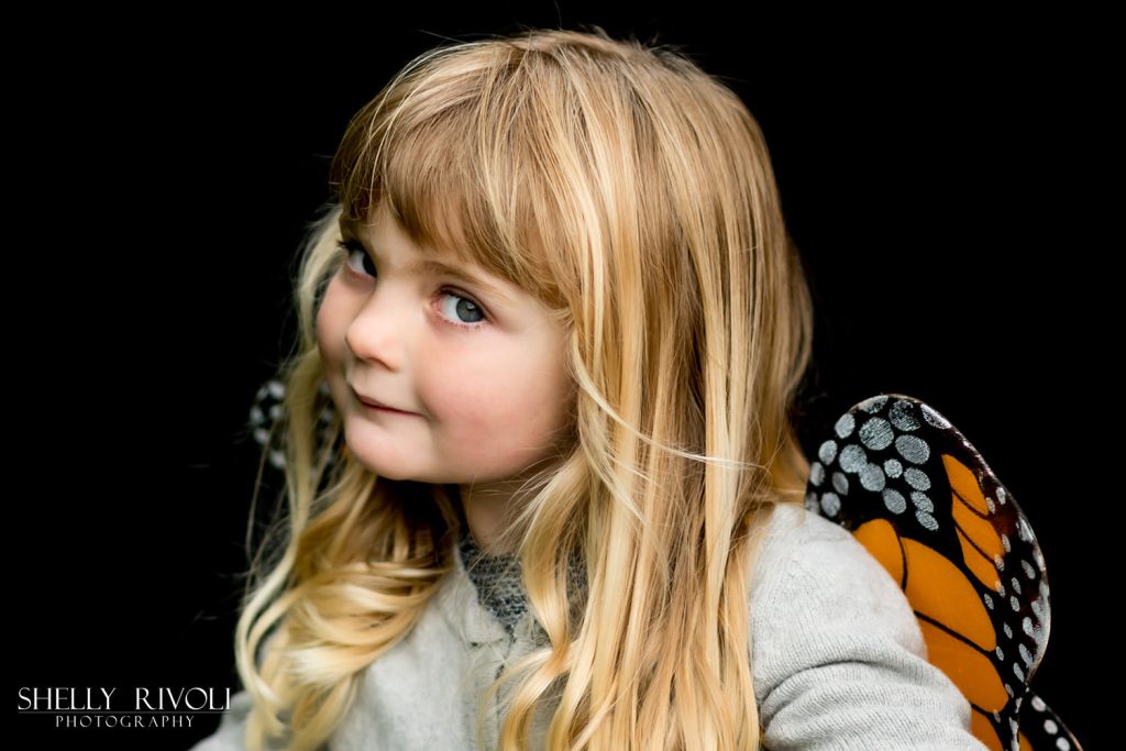 Children's portrait of young girl in butterfly wings by Shelly Rivoli