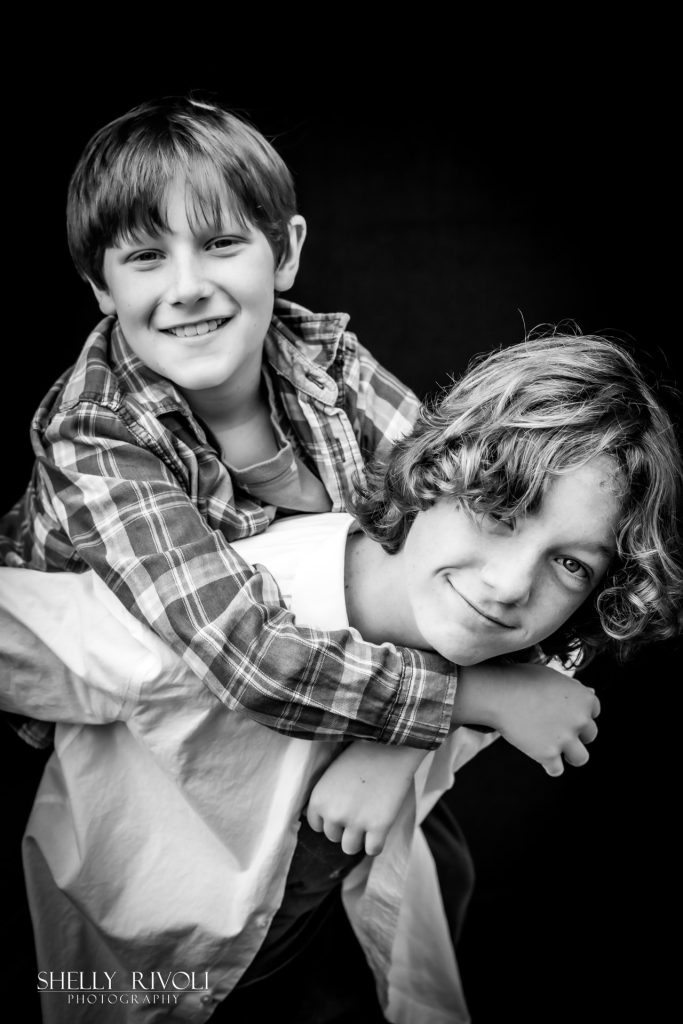BW children's portrait of brothers being silly