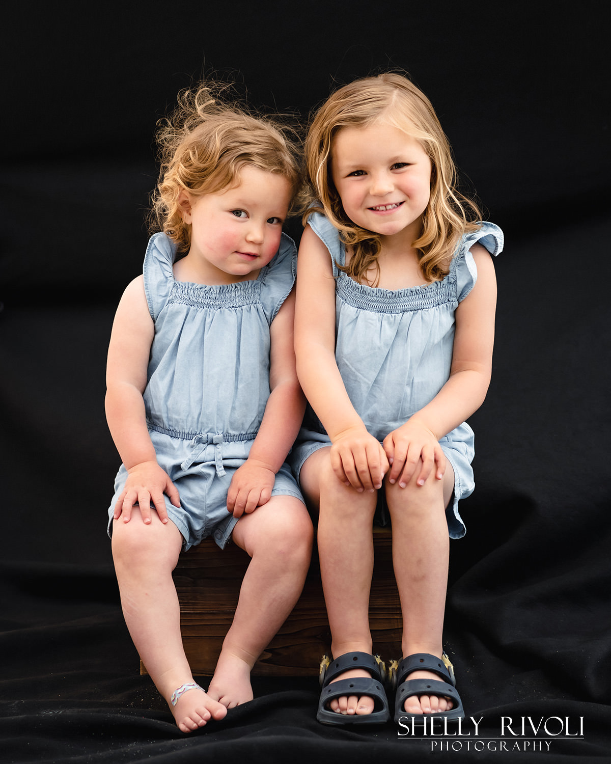 Young sisters sit for a children's portrait with photographer Shelly Rivoli