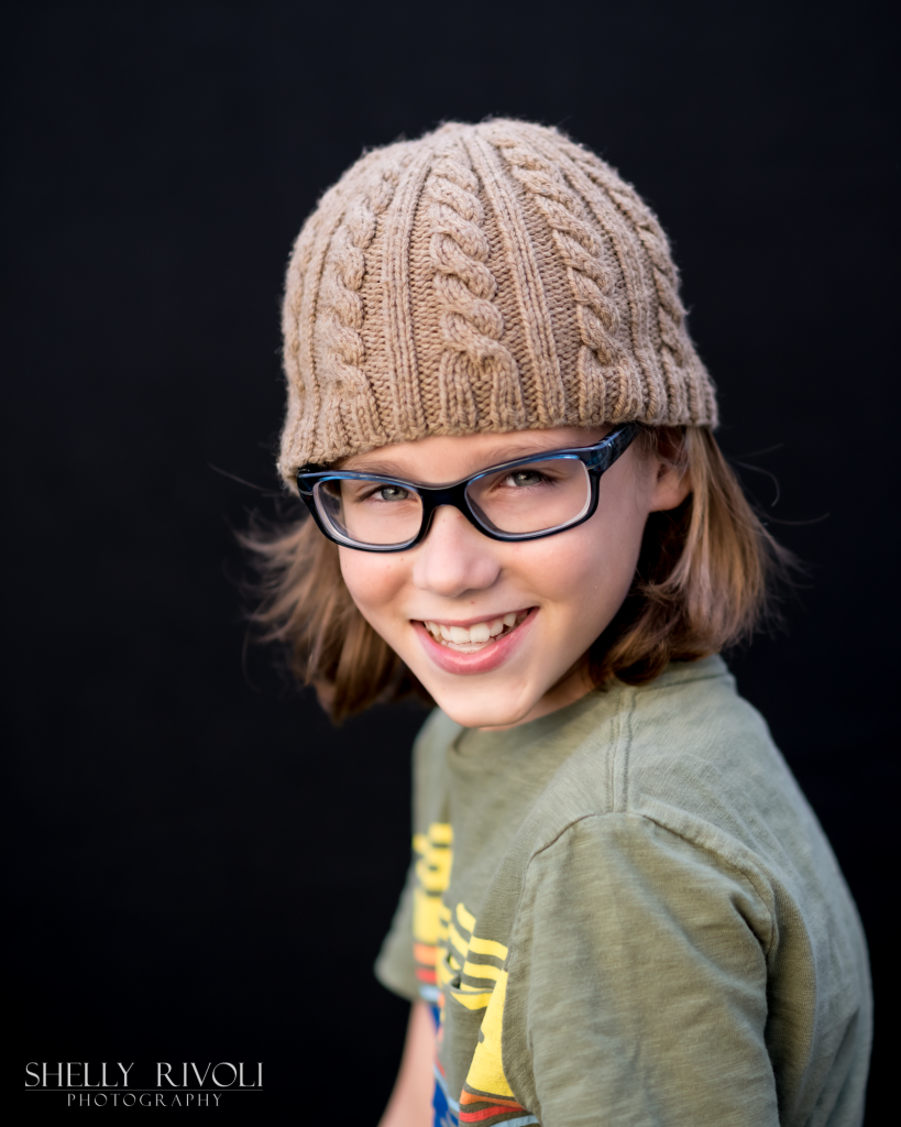 Children's portrait of tween wearing stocking cap and glasses by Bay Area photographer Shelly Rivoli
